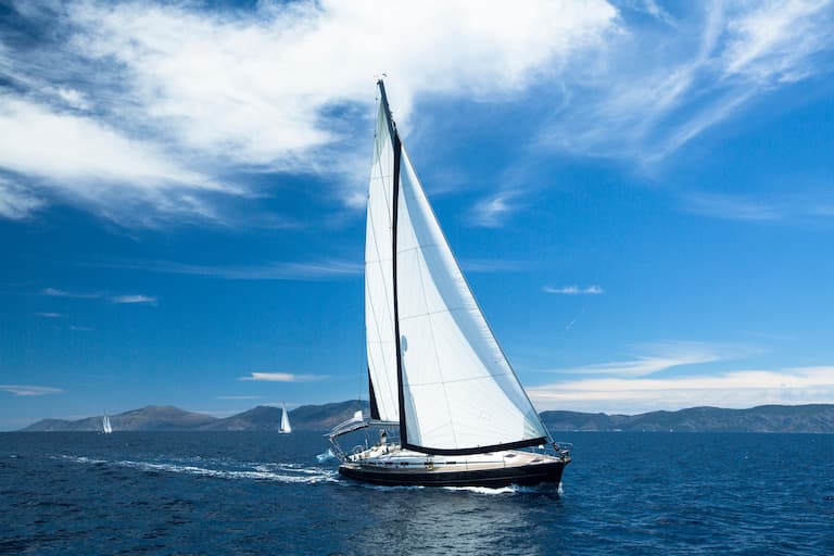 A sailboat in the ocean: Sailboats can tip over if they heel too much