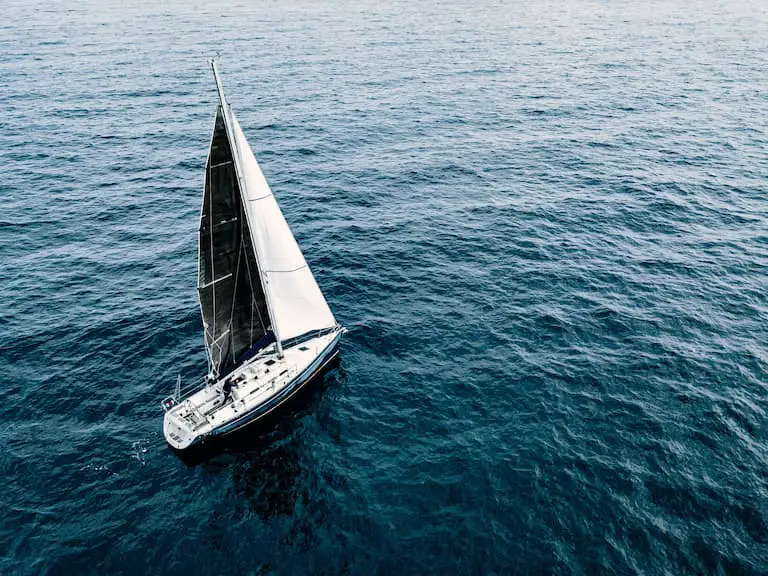 Sailboat on the ocean: saltwater will corrode a boat much quicker than freshwater.