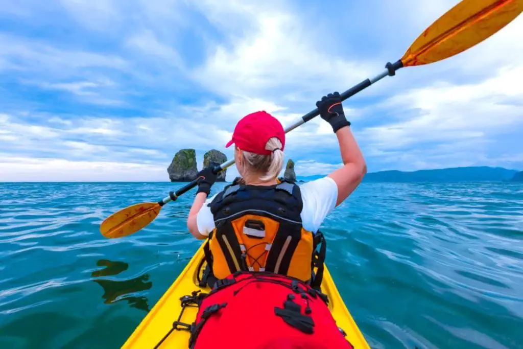 Woman kayaking: How to stop kayak paddle from dripping