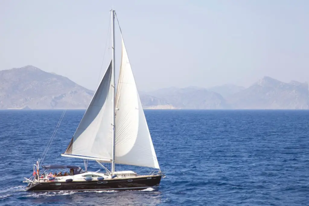 A single masted sailboat with two sails