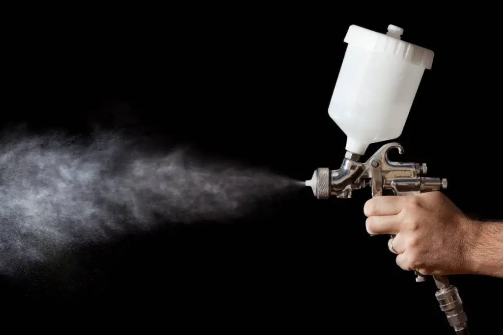 spray paint gun with black background